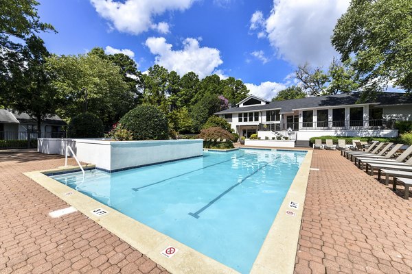 Luxurious poolside retreat with lounge chairs and umbrellas at Avana Chase Apartments