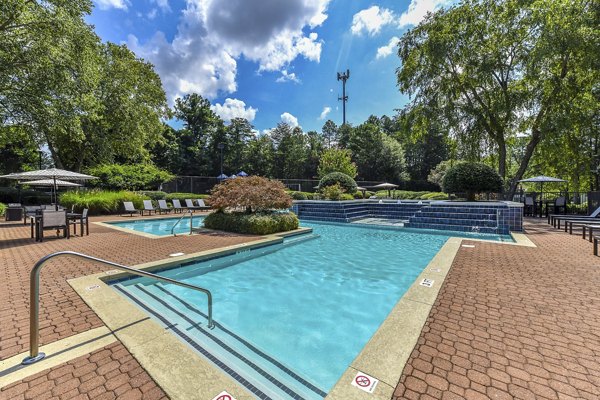 Outdoor pool area with lounge seating at Avana Chase Apartments