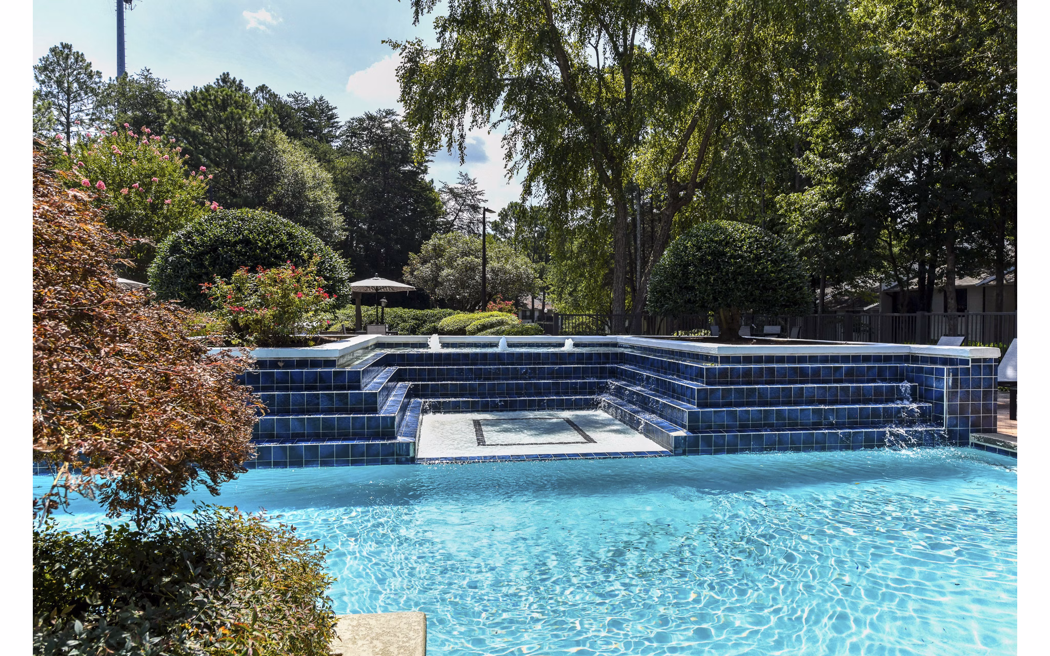 Luxurious pool area with sun loungers at Avana Chase Apartments