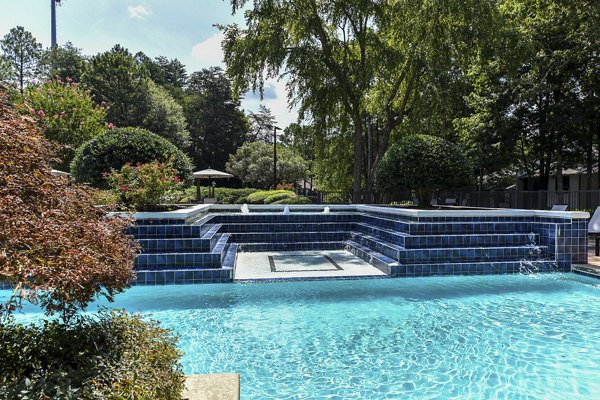 Luxurious pool area with sun loungers at Avana Chase Apartments