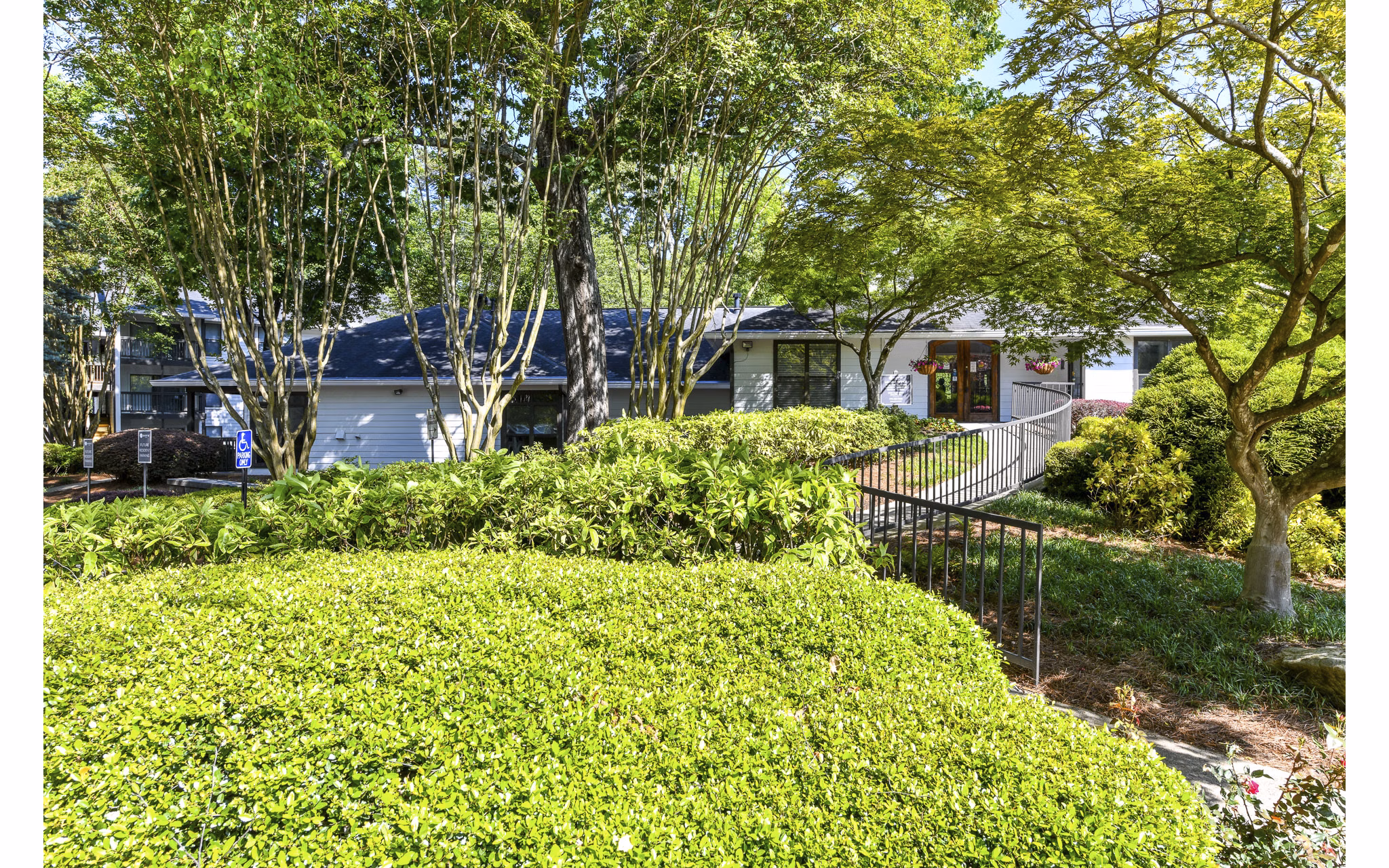 Avana Court: Elegant facade of luxury apartments in serene suburb, highlighting modern architecture and lush surroundings