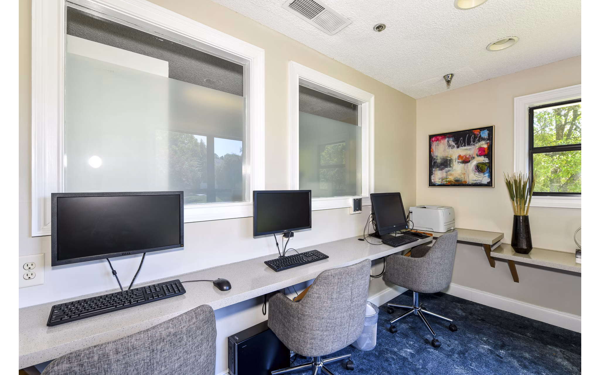 Business center with modern workstations at Avana Court Apartments, offering luxury workspace solutions