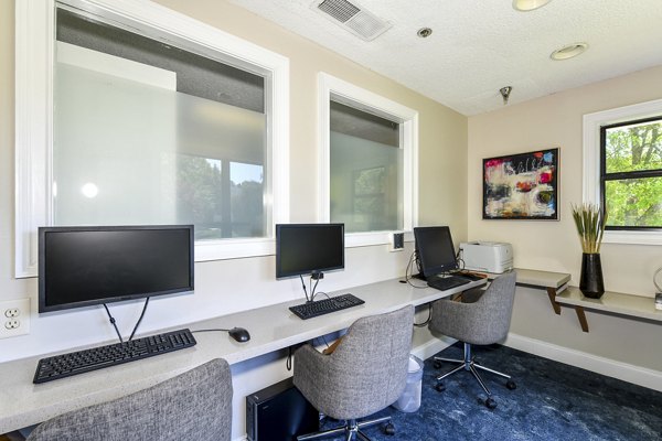 Business center with modern workstations at Avana Court Apartments, offering luxury workspace solutions