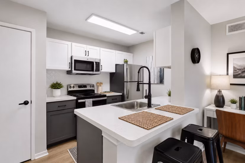 Modern kitchen featuring stainless steel appliances and sleek countertops at Avana Court Apartments