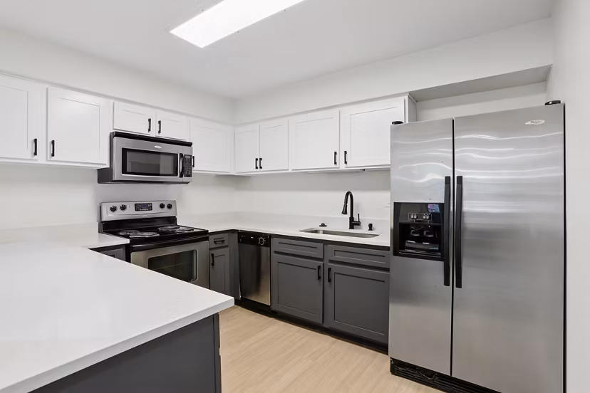 Modern kitchen with sleek countertops and stainless steel appliances in Avana Court Apartments