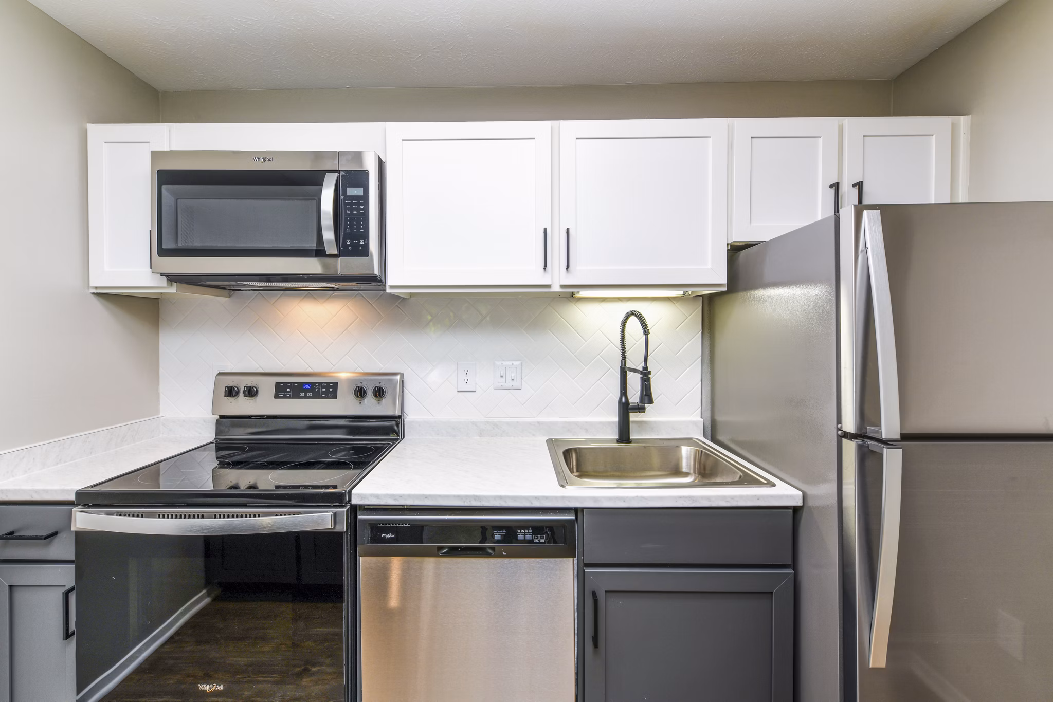 Modern kitchen with sleek countertops and stainless steel appliances in Avana Court Apartments