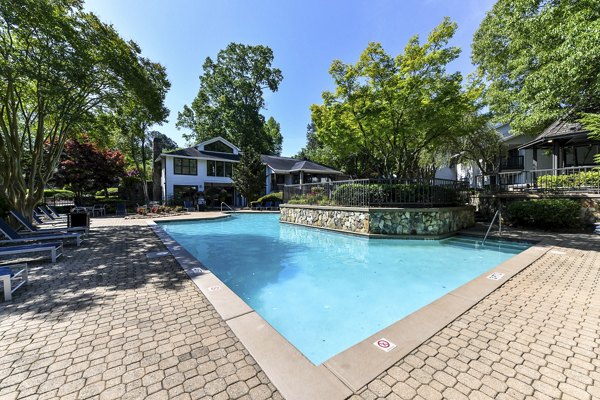 Luxurious pool area with lounge chairs at Avana Court Apartments, offering premium amenities for relaxation and recreation