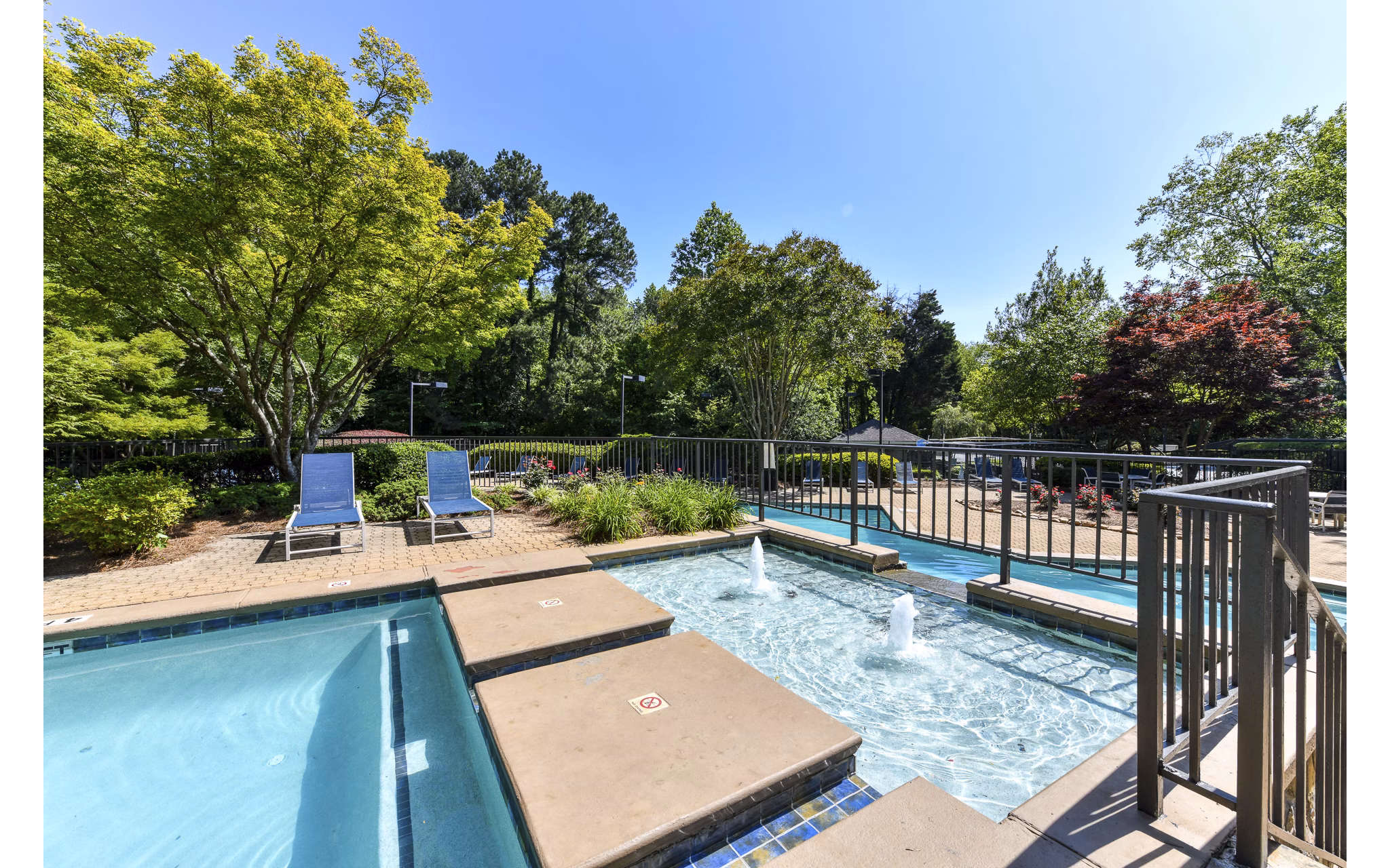 Luxurious pool with surrounding lounge chairs at Avana Court Apartments