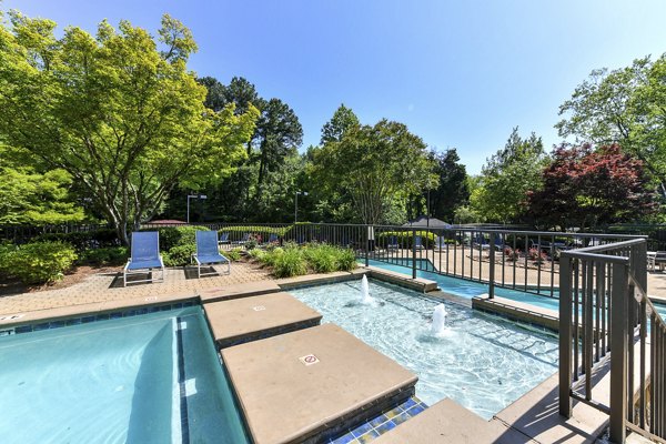 Luxurious pool with surrounding lounge chairs at Avana Court Apartments