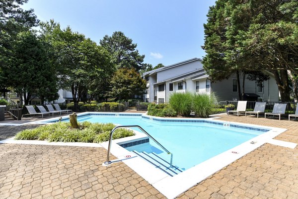 Relaxing pool area with lounge chairs at Avana Court Apartments, ideal for leisure and recreation