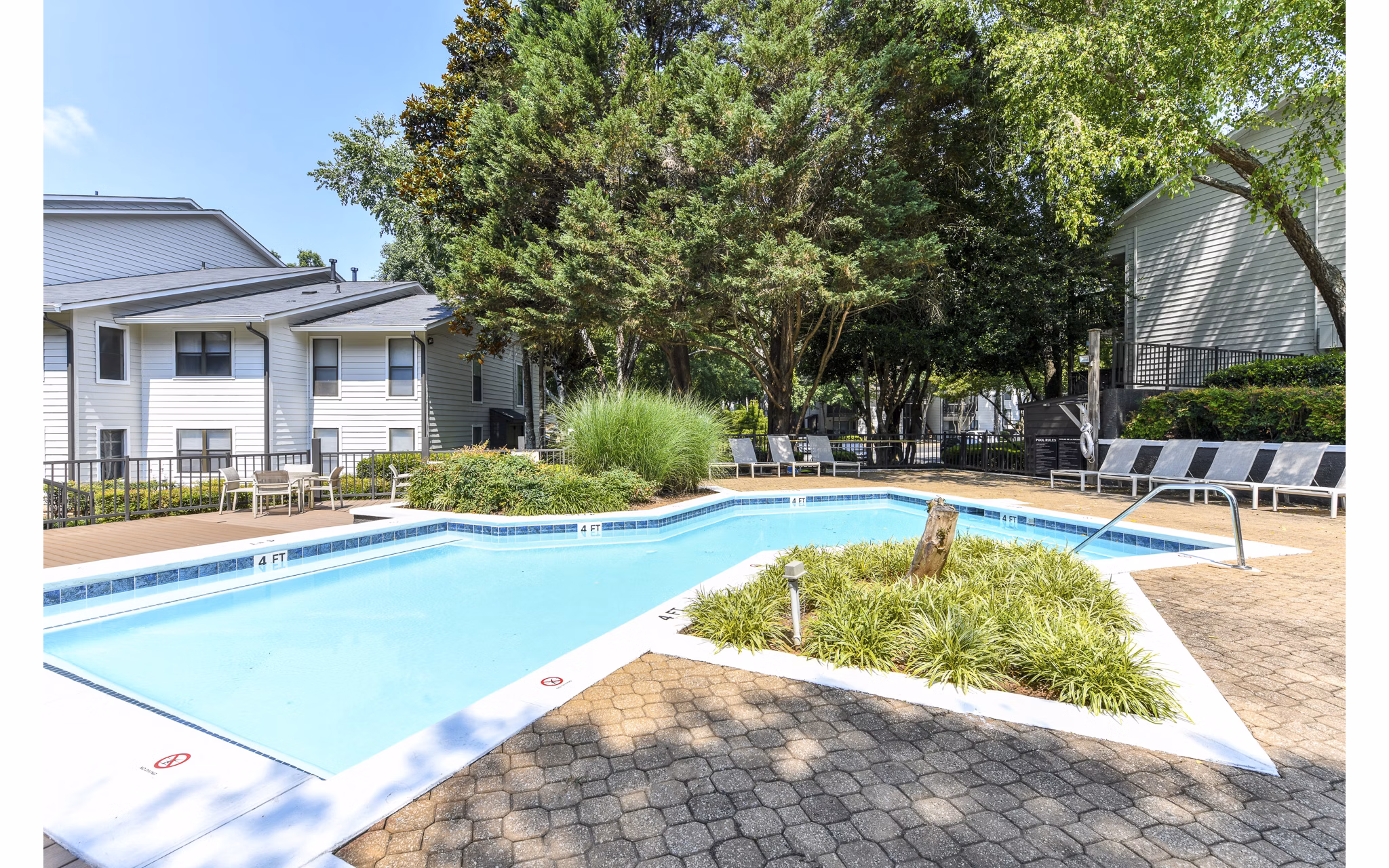 Sparkling outdoor pool with lounge chairs at Avana Court Apartments