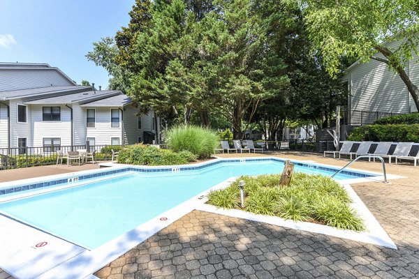 Sparkling outdoor pool with lounge chairs at Avana Court Apartments