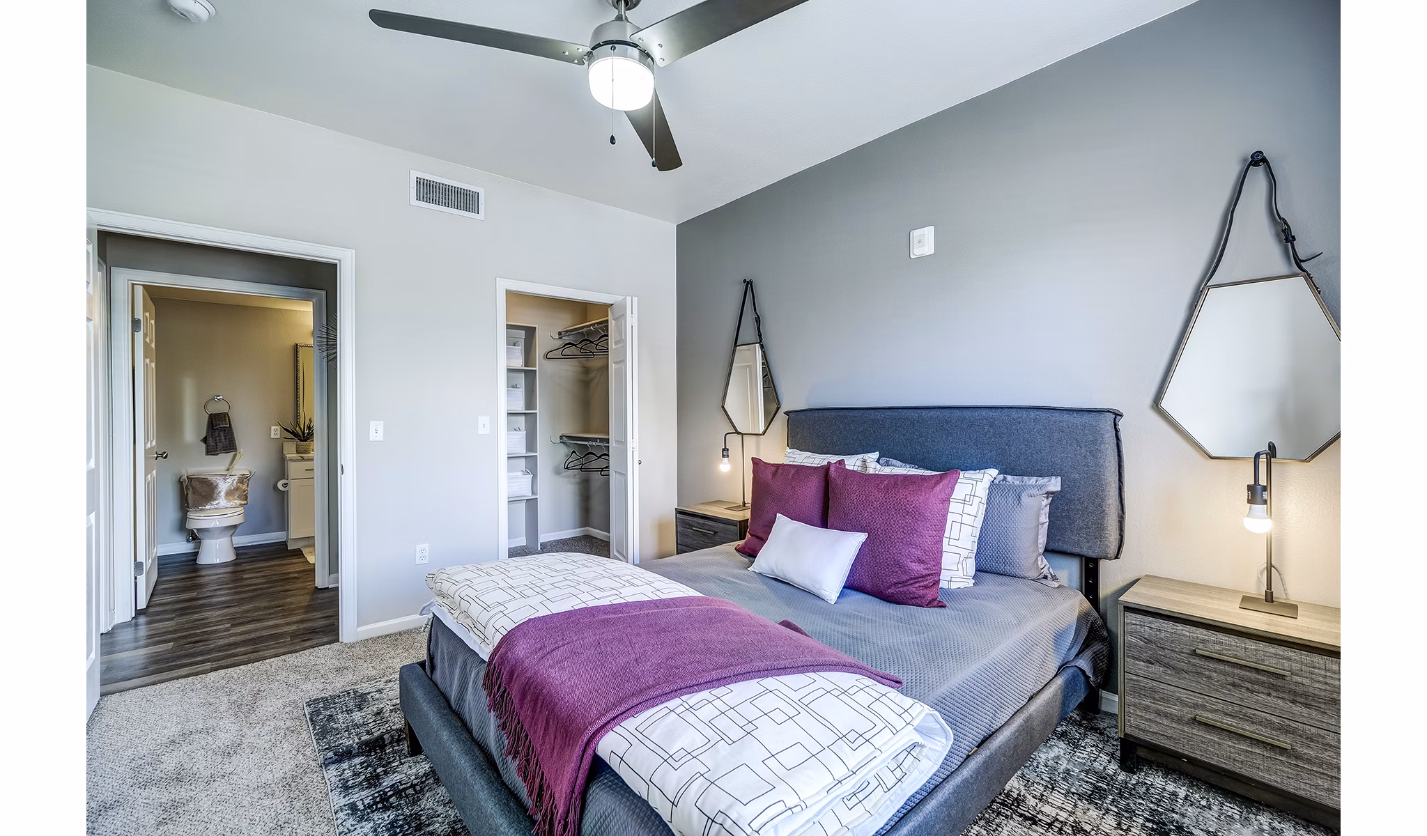 Modern bedroom with plush bedding and neutral tones at The Fletcher Southlands Apartments