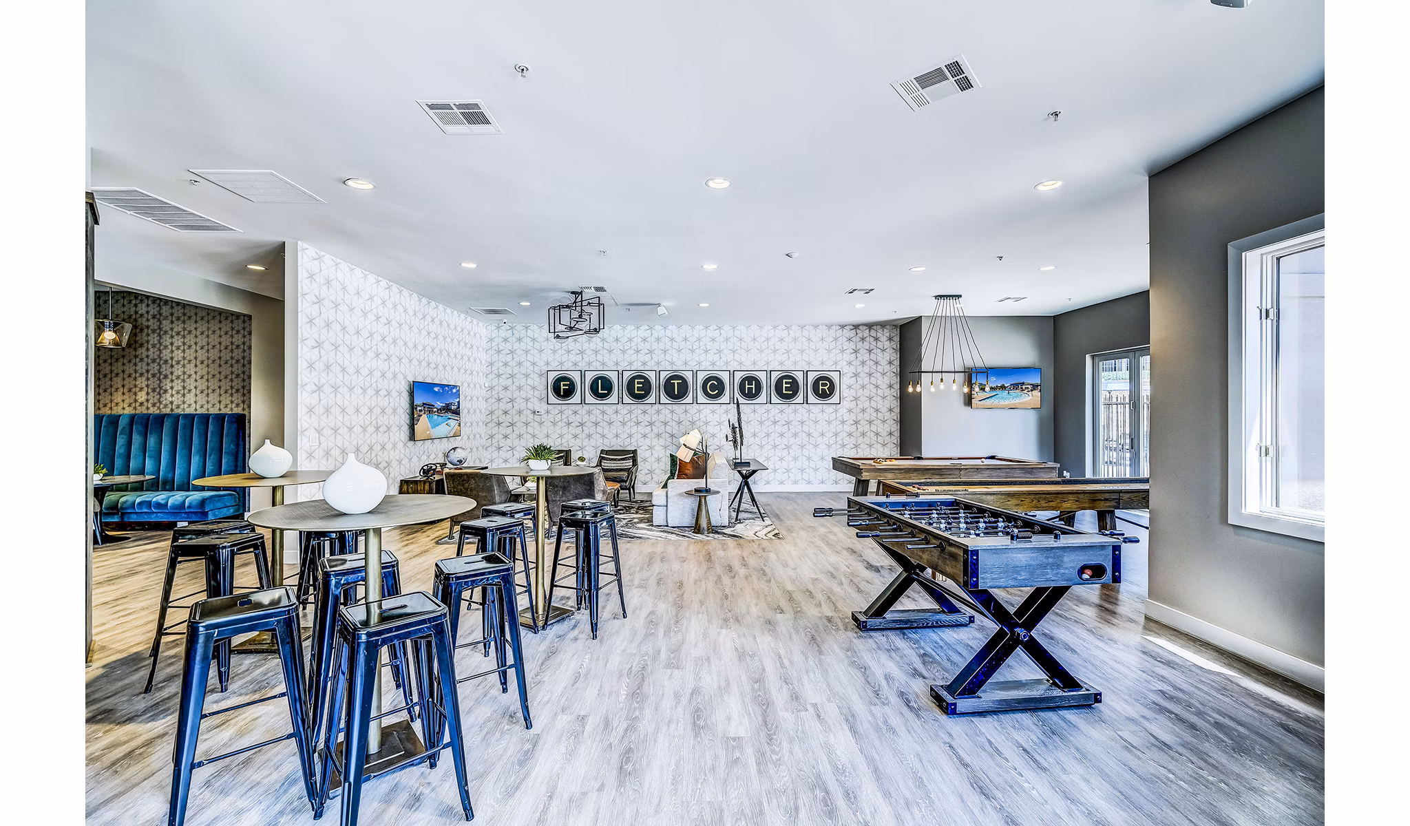 Game room with billiards and seating area at The Fletcher Southlands Apartments in Aurora, CO, offering fun recreational activities for residents