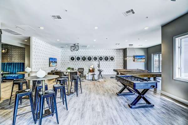 Game room with billiards and seating area at The Fletcher Southlands Apartments in Aurora, CO, offering fun recreational activities for residents