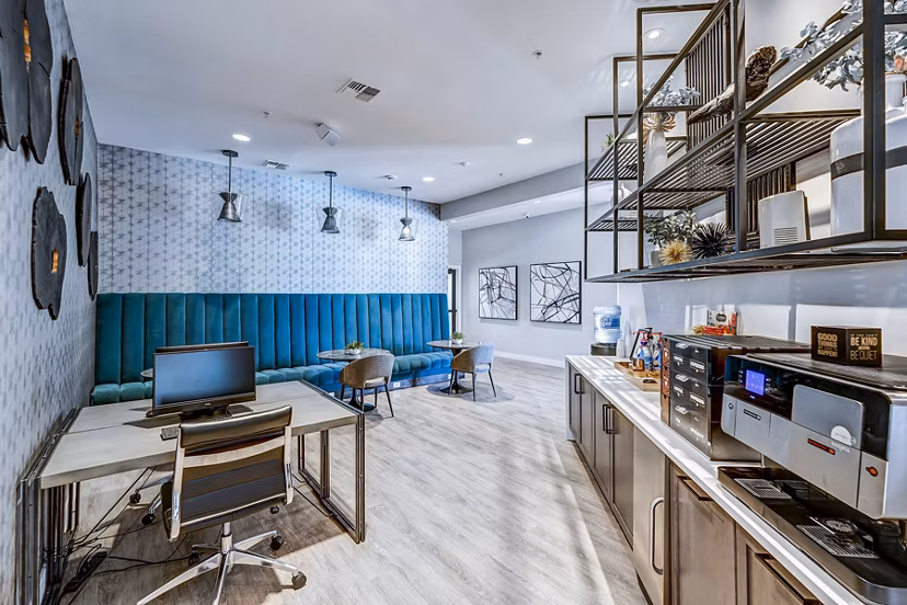 Modern business center featuring workstations at The Fletcher Southlands Apartments