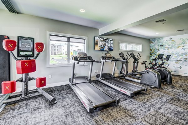 State-of-the-art fitness center at The Fletcher Southlands Apartments featuring modern exercise equipment and spacious workout areas