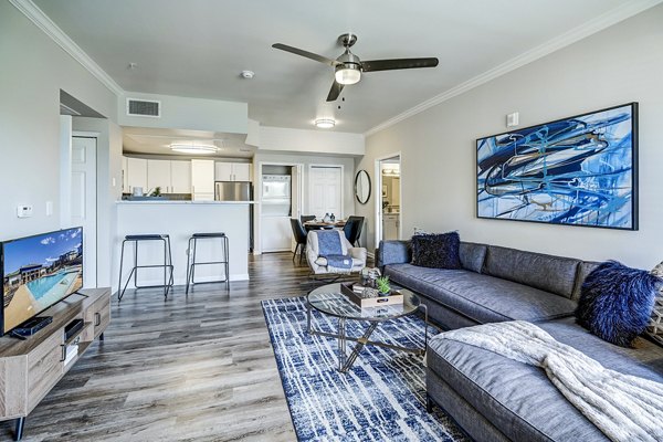 Spacious living room with modern decor at The Fletcher Southlands Apartments