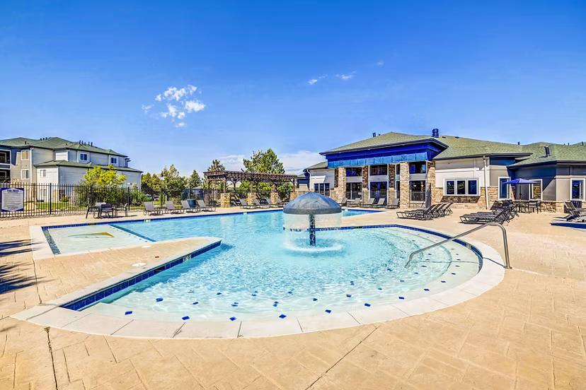 Resort-style pool with lounge chairs and cabanas at The Fletcher Southlands Apartments
