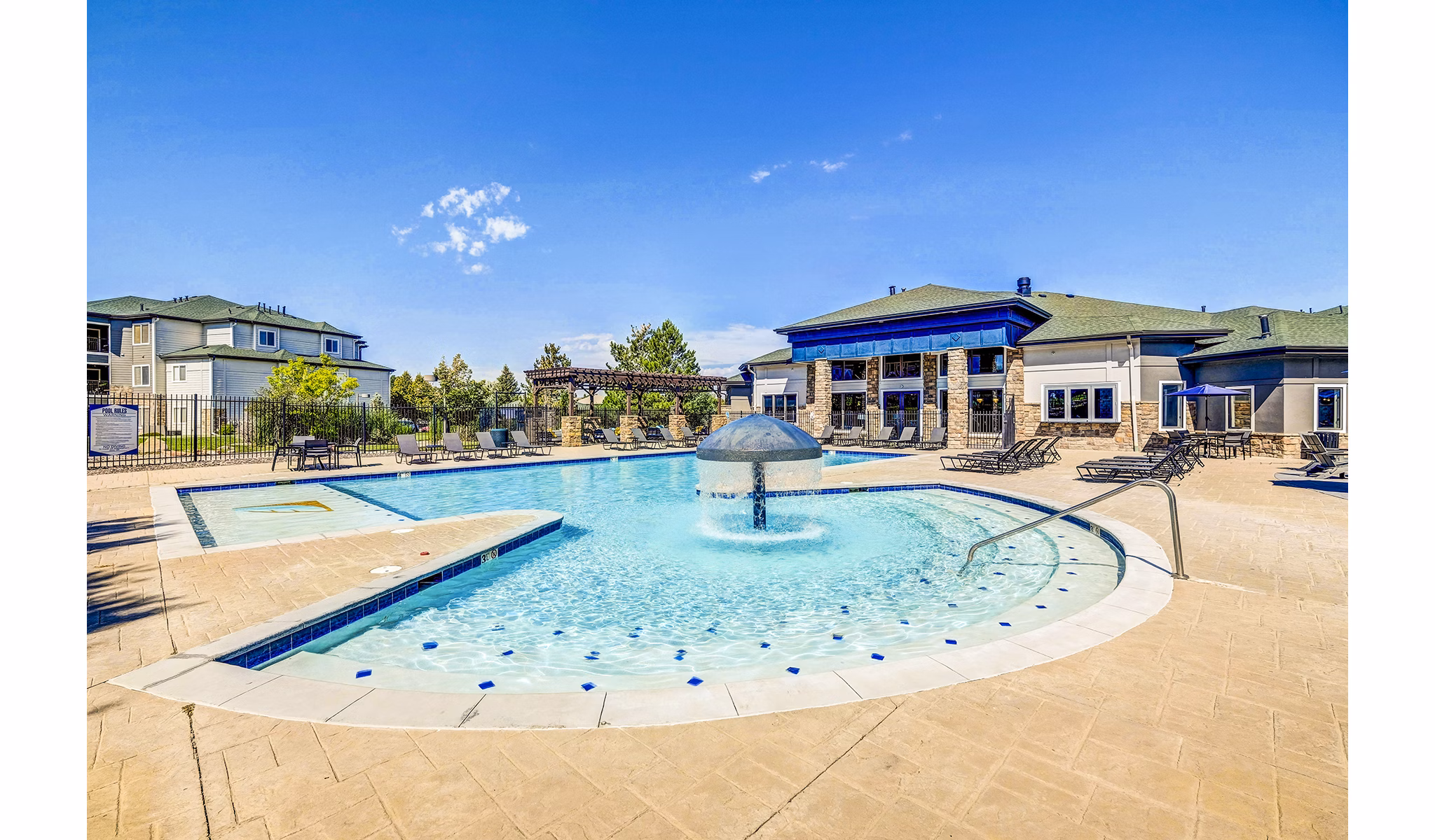 Resort-style pool with lounge chairs and cabanas at The Fletcher Southlands Apartments