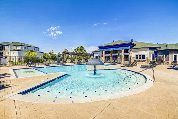 Resort-style pool with lounge chairs and cabanas at The Fletcher Southlands Apartments