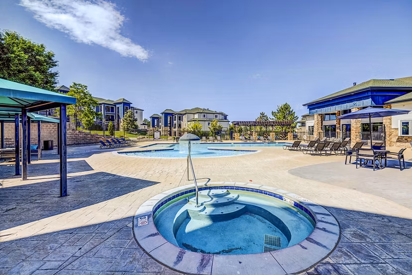 Relaxing hot tub at The Fletcher Southlands Apartments featuring modern design and lush landscaping for ultimate luxury living experience