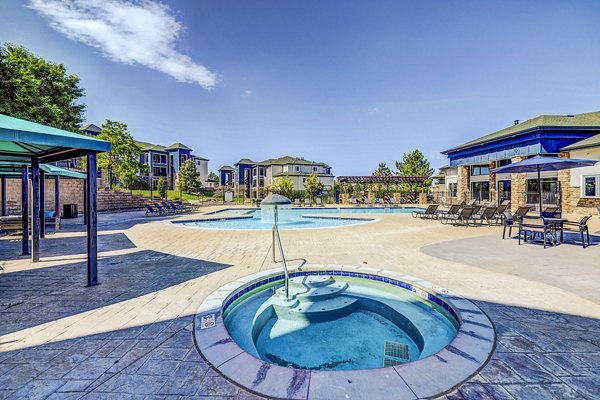 Relaxing hot tub at The Fletcher Southlands Apartments featuring modern design and lush landscaping for ultimate luxury living experience