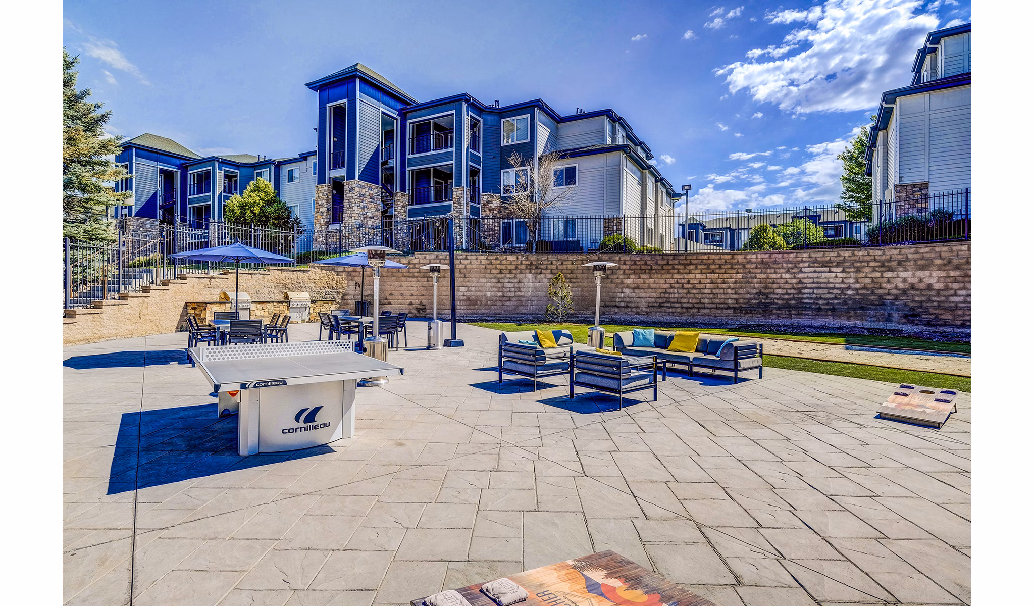 Recreational area with seating and greenery at The Fletcher Southlands Apartments