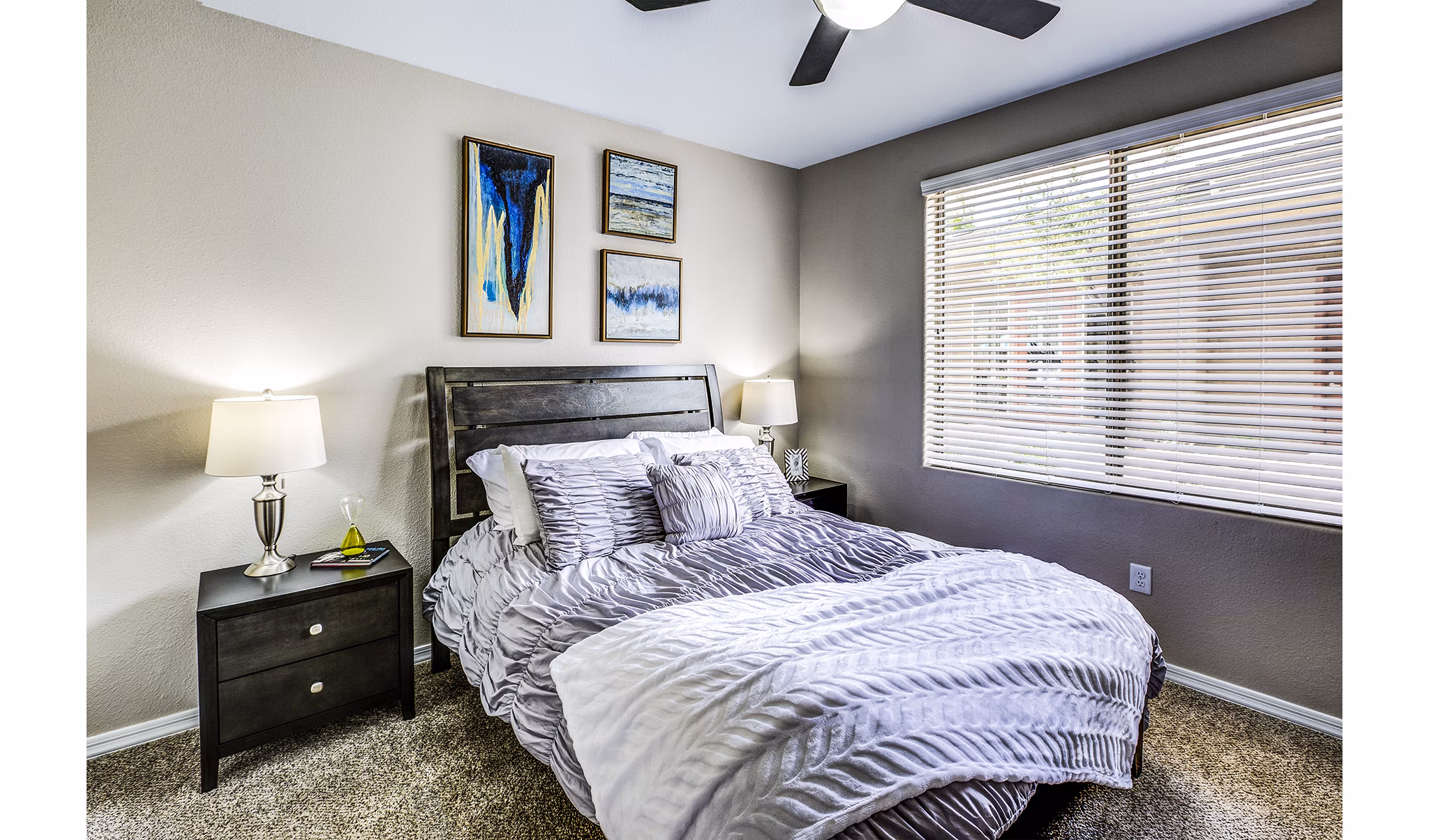 Bedroom featuring modern design and cozy ambiance at Laguna at Arrowhead Ranch Apartments