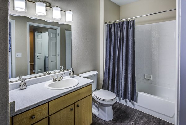 Laguna at Arrowhead Ranch: Modern bathroom featuring double sinks and sleek finishes in luxury apartments