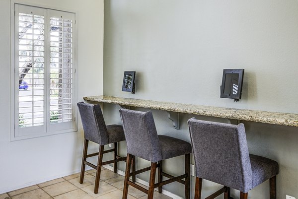 Business center with modern workstations at Laguna at Arrowhead Ranch Apartments, ideal for residents seeking professional workspace solutions