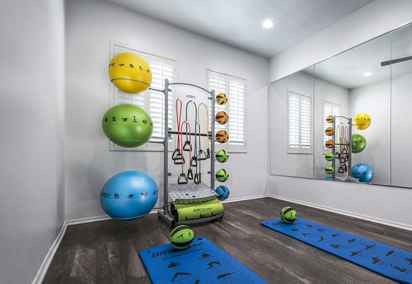 Laguna at Arrowhead Ranch Apartments: Modern fitness center equipped with cardio machines and free weights