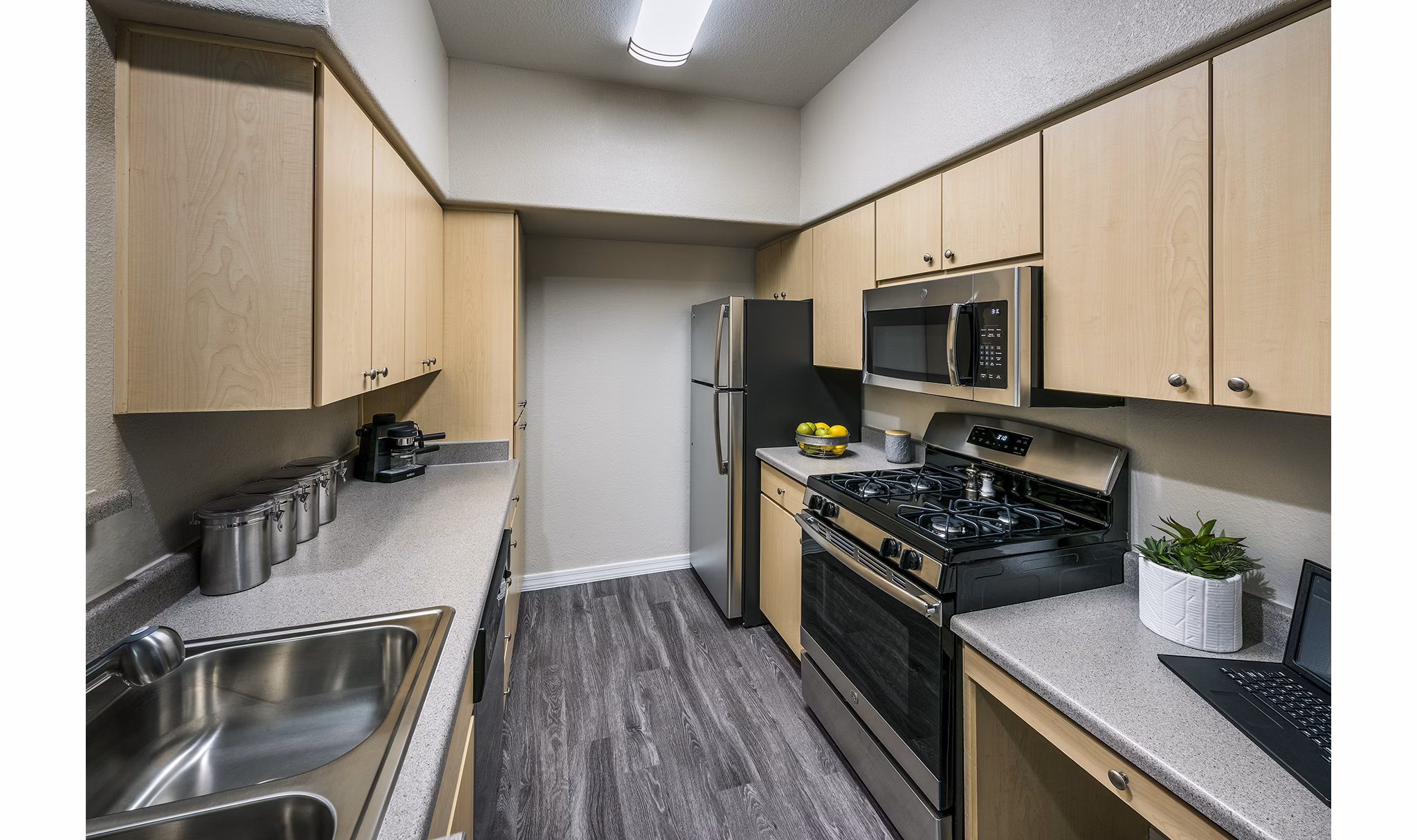 Modern kitchen with stainless steel appliances at Laguna at Arrowhead Ranch Apartments