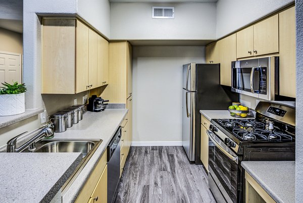 Modern kitchen with stainless steel appliances at Laguna at Arrowhead Ranch Apartments