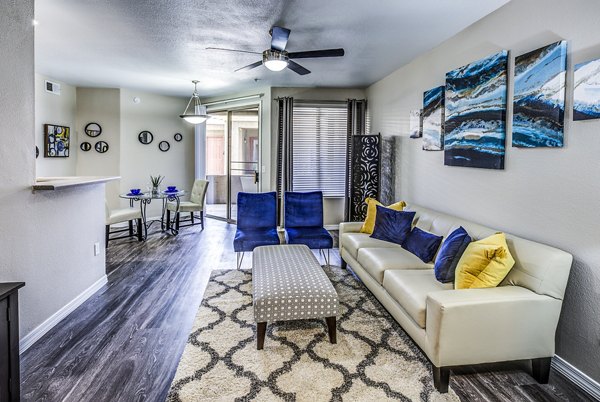 Modern living room with stylish decor and large windows at Laguna at Arrowhead Ranch Apartments