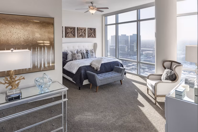 Modern bedroom with large windows and stylish decor at 2929 Weslayan Apartments