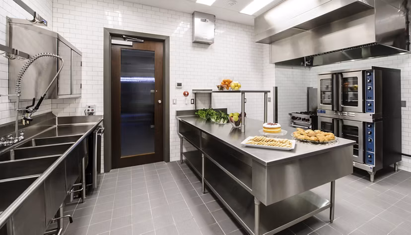 Modern clubhouse kitchen with marble countertops and bar seating at 2929 Weslayan Apartments