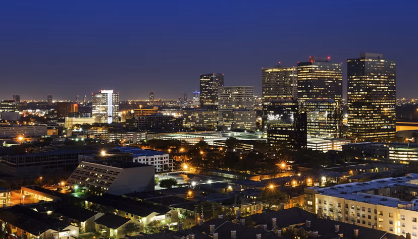 City skyline view from a high-rise balcony at 2929 Weslayan Apartments in Houston