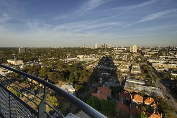 Exterior view of 2929 Weslayan Apartments showcasing city skyline in Houston, luxury living
