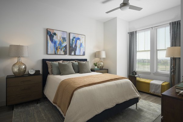 Cozy bedroom with modern decor at The Tyler Apartments, a luxury Greystar community