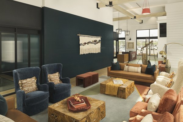 Chic clubhouse with modern seating and decor at The Tyler Apartments in  community