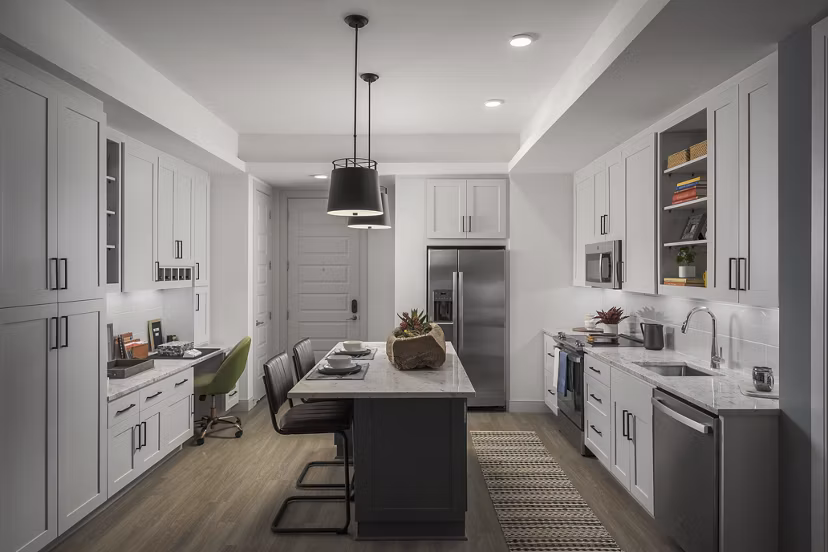 Modern kitchen with stainless steel appliances at The Tyler Apartments