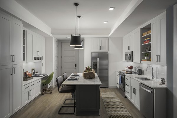 Modern kitchen with stainless steel appliances at The Tyler Apartments