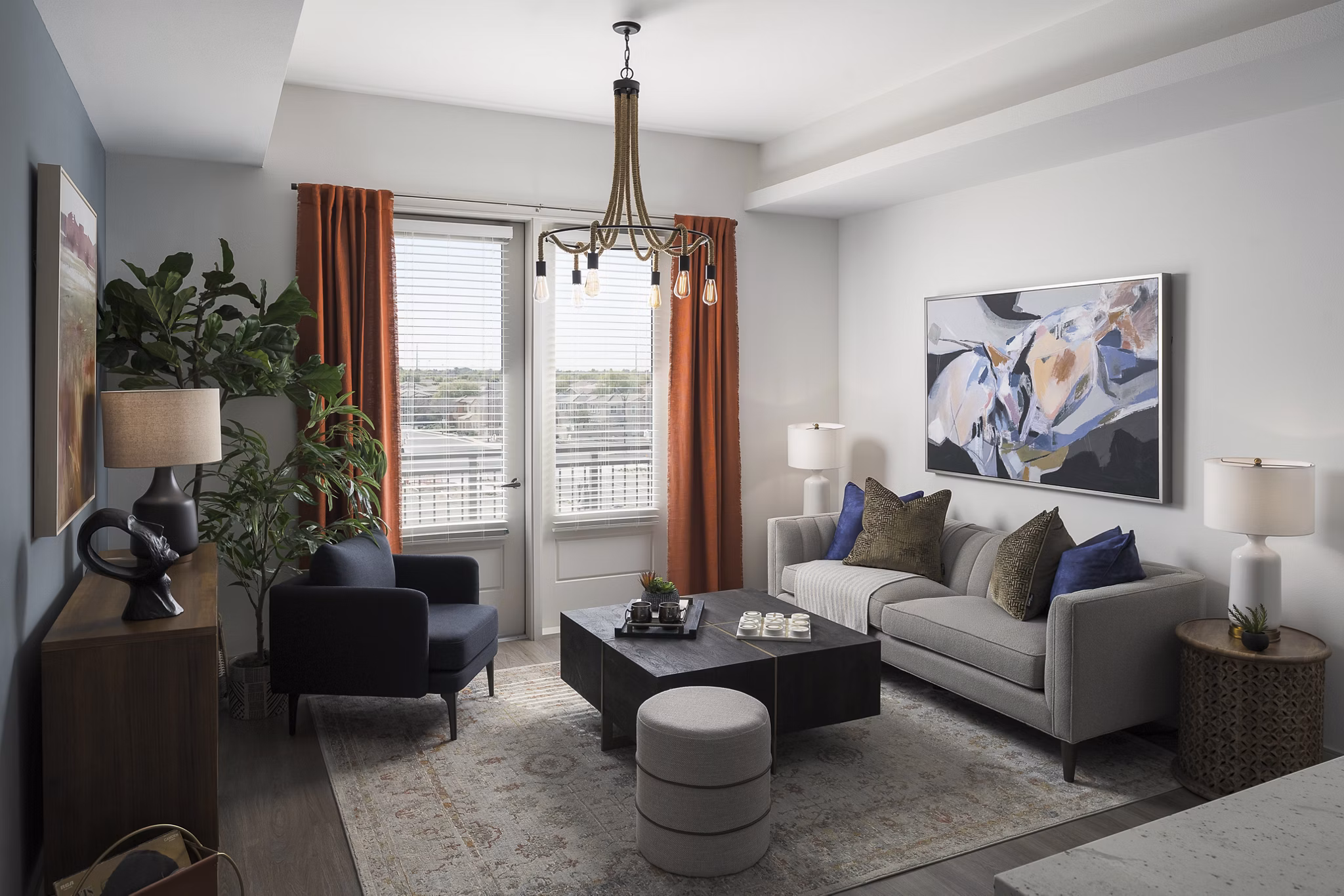 Spacious living room with modern furnishings in The Tyler Apartments