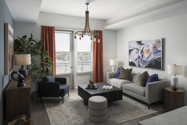 Spacious living room with modern furnishings in The Tyler Apartments
