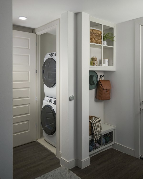 Laundry room with modern appliances at The Tyler Apartments in luxury Greystar community
