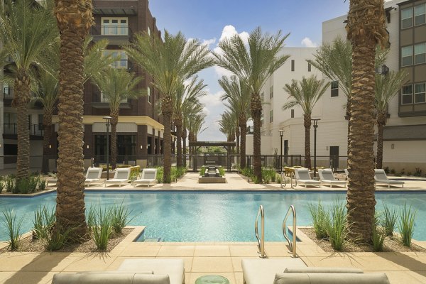 Luxurious pool with stylish lounge areas at The Tyler Apartments