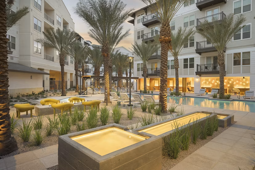 The Tyler Apartments: Serene courtyard with lush greenery and seating areas for relaxation