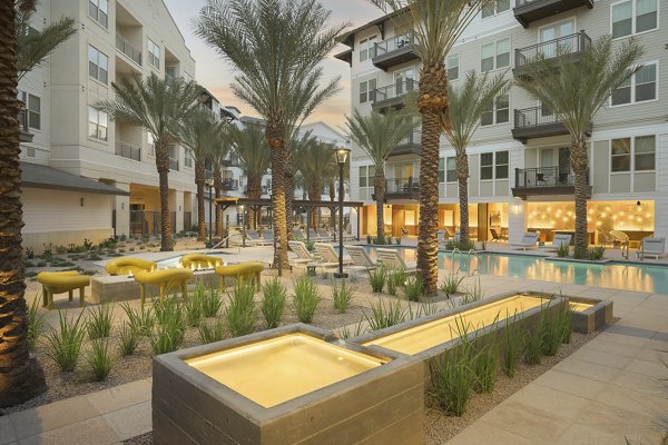 The Tyler Apartments: Serene courtyard with lush greenery and seating areas for relaxation