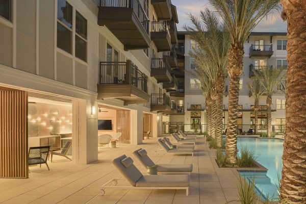 Patio at The Tyler Apartments: Modern outdoor space with comfortable seating and lush landscaping in luxury urban setting